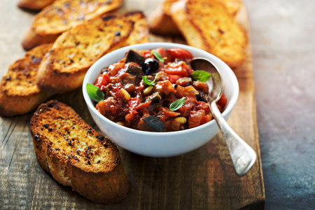 Eggplant caponata crostini or bruschetta on garlic breadの写真素材