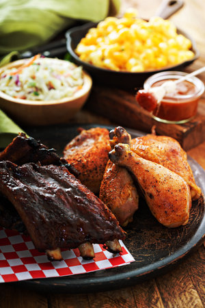 Grilled or smoked ribs and chicken with barbeque sauceの写真素材