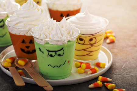 Funny Halloween themed puddings in cups with whipped creamの写真素材