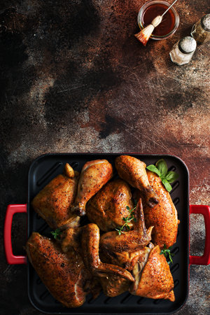 Grilled or smoked whole carved chicken on a panの写真素材