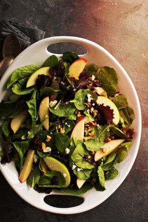 Fall salad with spring mix, apple, nuts and cranberryの写真素材