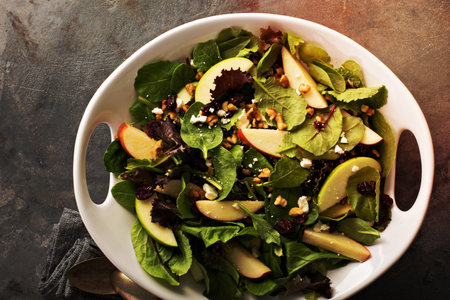 Fall salad with spring mix, apple, nuts and cranberryの写真素材