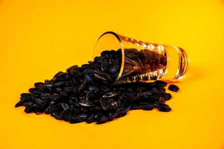 white sunflower seeds in glass jar. in bucket sunflower seeds on black background. concept white sunflower seedsの写真素材