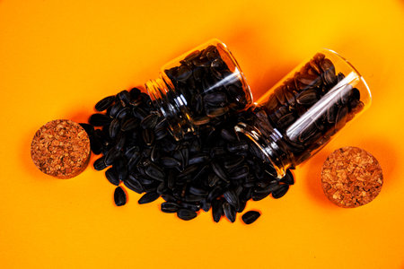 white sunflower seeds in glass jar. in bucket sunflower seeds on black background. concept white sunflower seedsの写真素材