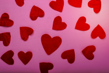 Heart-shaped felt figures on a pink background. Valentine's Day background.の写真素材