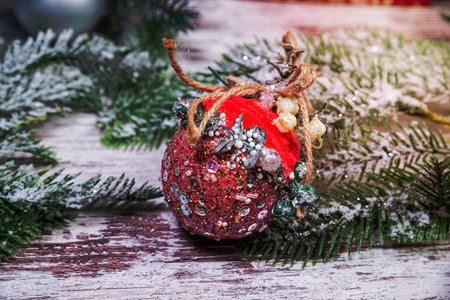 Creative diy craft hobby. Making handmade craft christmas ornaments and balls with felt spruce tree. Woman's leisure, holiday decorations. Closeup of female hands at whiteの写真素材
