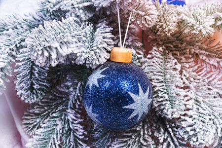Creative diy craft hobby. Making handmade craft christmas ornaments and balls with felt spruce tree. christmas tree with colorful balls and gift boxes over white brick wall with blue and white ballsの写真素材