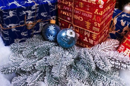 Creative diy craft hobby. Making handmade craft christmas ornaments and balls with felt spruce tree. christmas tree with colorful balls and gift boxes over white brick wall with blue and white ballsの写真素材