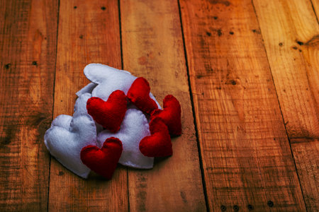 Group of hearts made of felt on wooden table. Valentine's day background.の写真素材