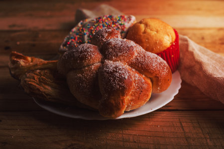 Pan de muerto and other sweet breads on a wooden table. Typical Mexican dessert.の写真素材