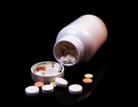 Top view mockup bottle for pills and vitamins on black background, natural organic bio supplement
Medical pills in white jar on an isolated black background with reflectionの写真素材