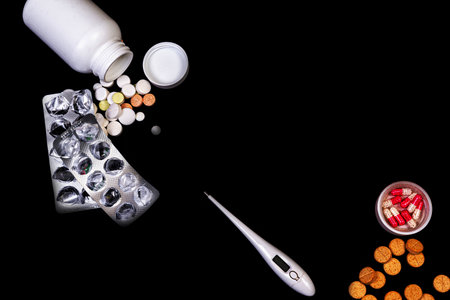 Top view mockup bottle for pills and vitamins on black background, natural organic bio supplement
Medical pills in white jar on an isolated black background with reflectionの写真素材