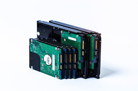 Hard disk drive HDD of different size isolated on white. Detailed view of the inside of a hard disk drive HDD Hard Drives data storage side by side with silver light colorの写真素材