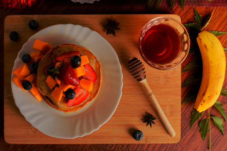 Hotcakes served ready for breakfast. Hotcakes decorated with strawberries.の写真素材