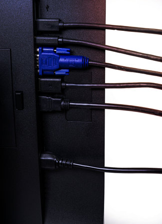 IT engineer Man hand inserts cable into monitor. Man hand connecting the DVI cable for monitor to computer PC. VGA DVI DisplayPort and power cable. close up in the hands of an . copy space.の写真素材