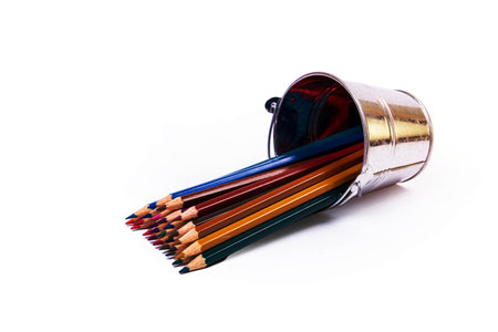 multi-colored pencils in a wine glass and a bucket. Selective blurred a group of coloring pencils in a wine glass on the isolated white or black background , Modern art. Modern designの写真素材