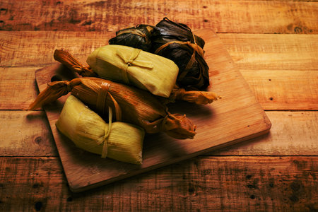 Tamales, typical Mexican food made from corn on a wooden table.の写真素材