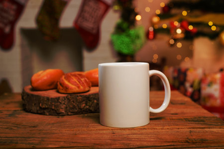 White cup on wooden table. Mug and breads on table with christmas background.の写真素材