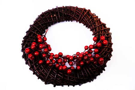 Wreath woven from the branches of the vine isolated red white blue pink brown vine wreath with flowers fruits rowanの写真素材