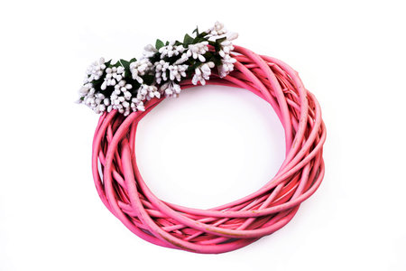 Wreath woven from the branches of the vine isolated red white blue pink brown vine wreath with flowers fruits rowanの写真素材