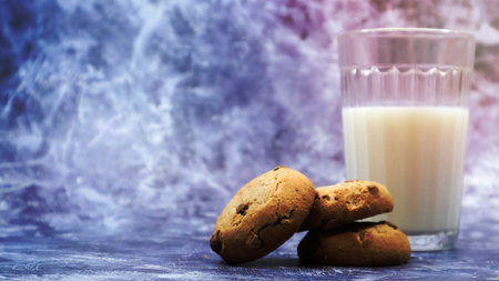 American gluten free chocolate chip cookies with glass glass of vegetable milk on gray background. Chocolate chip cookies. Sweet pastries, dessert. Culinary background. Copy spaceの写真素材