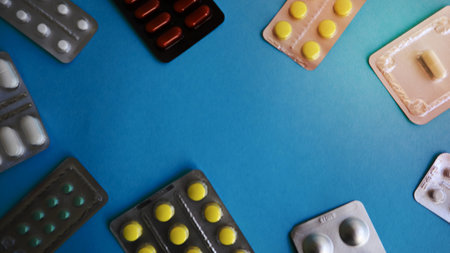 colored medicines and pills in packs on a blue background. Copy space. Pharmacology and medicine are fighting for health. Treatment of various diseasesの写真素材