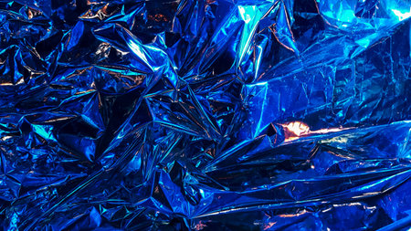 Decoration background from crumpled metal foil, shiny silver surface. Beautiful abstract foil texture as a background for design. Non-ferrous metal. Crumpled brown paper from a giftの写真素材