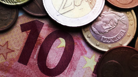 Euro banknotes and coins as background. Shot looking at the Euro currency. Coins are stacked on top of each other in different positions. Money conceptの写真素材