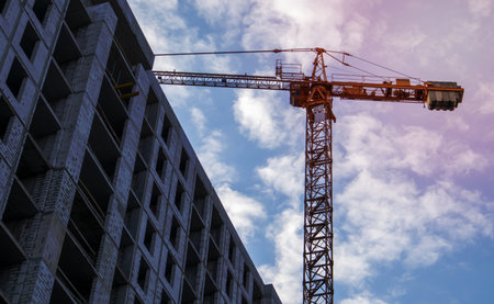 Large construction site. The process of capital construction of a high-rise residential complex. Concrete building, construction, industrial site. Industrial crane on the background of the skyの写真素材