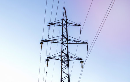 High voltage power lines, post or tower against the backdrop of a beautiful sky. Sequentially ordered high energy pylonsの写真素材