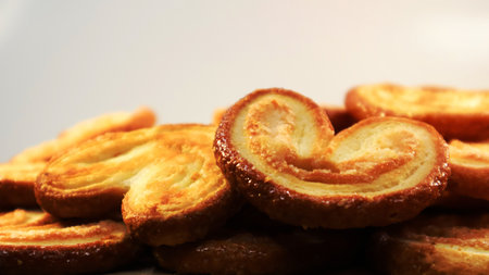 Fresh puff pastry palm cookies in the shape of a heart. Classic French pastries. Pig ear, elephant ear cookies, French heartsの写真素材