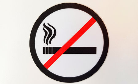 Round red and black no smoking sign, sticker in a public place on a white background.の写真素材
