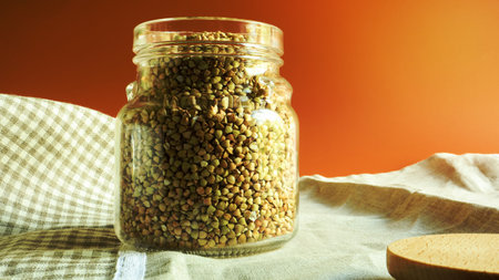 Green sprouts of raw organic buckwheat in a glass jar for cereals. Vegan food concept. Organic food. The concept of diet, weight loss, healthy and proper nutrition. Copy space for textの写真素材