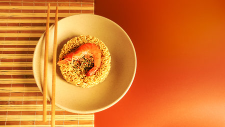 Spicy instant noodle soup with shrimp. shrimp soup, cooking, food. Raw dried circle-shaped vermicelli in a plate. Asian food. pasta, for the preparation of which it is enough to pour boiling water.の写真素材