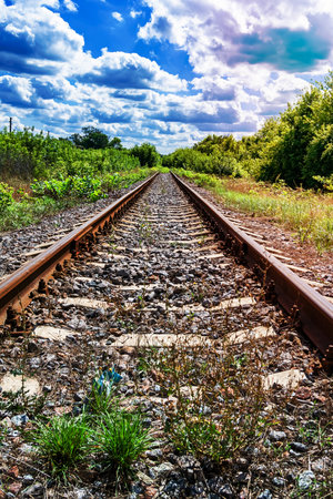 Photography to theme railway track after passing train on railroad, photo consisting of long railway track before fast movement train by railroad, railway transportation track for train at railroadの写真素材