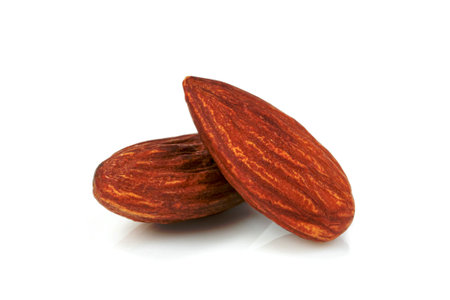 almonds natural roasted isolated on white backgroundの写真素材