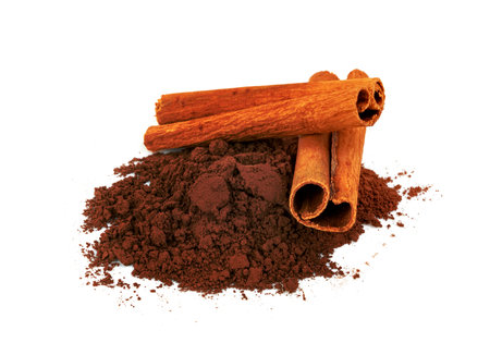 cinnamon powder and sticks isolated on a white backgroundの写真素材