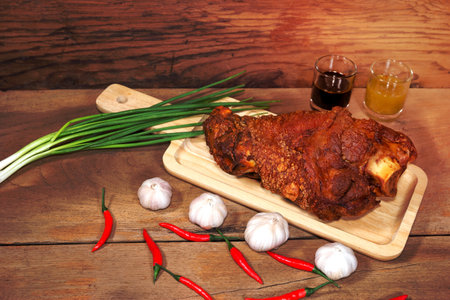 fried pork leg cooked on chopping blockの写真素材