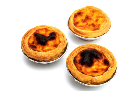 egg tart in aluminum foil cup isolated on white backgroundの写真素材