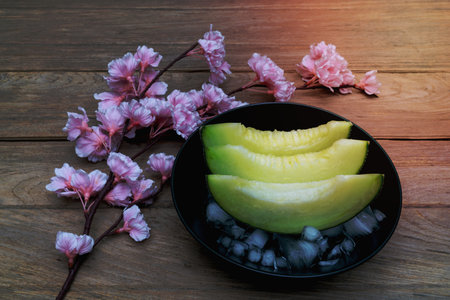 melon sliced with ice on wood backgroundの写真素材