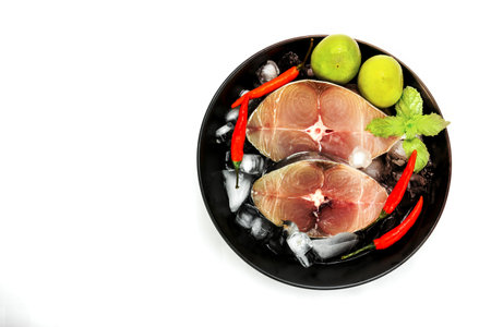Fillet of Spanish Mackerel Slide with ice cubes on black dish ,Scomberomorusの写真素材