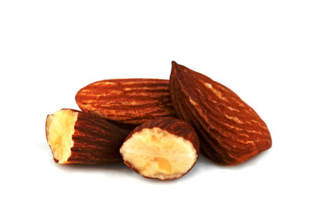broken almonds natural roasted isolated on white backgroundの写真素材