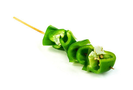 green chopped sweet bell pepper with wood skewer isolated on white backgroundの写真素材