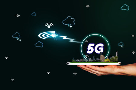 5G network interface and icon concept,hand holding mobile smart phone with city modelの写真素材