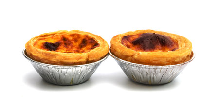 egg tart in aluminum foil cup isolated on white backgroundの写真素材