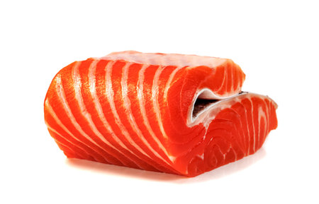 Piece of fresh salmon fillet sliced isolated on white backgroundの写真素材
