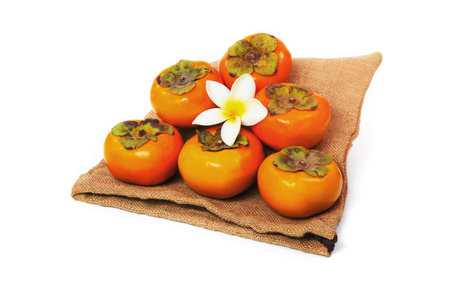 Persimmon with sack isolated on white backgroundの写真素材