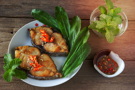 King mackerel steak on wood background,fried fishの写真素材