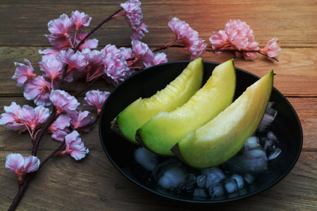 melon sliced with ice on wood backgroundの写真素材