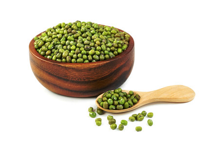 green mung beans with bowl and wooden spoon isolated on white backgroundの写真素材